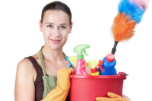 Professional cleaner preparing a kitchen and living area in Enfield